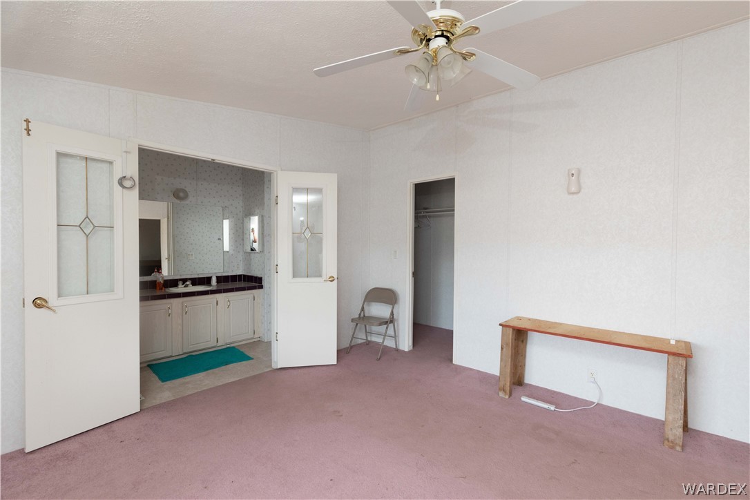 7374 Windmill Road Kingman, AZ 86401 - Photo 23 of 49 a living room with furniture and a ceiling fan