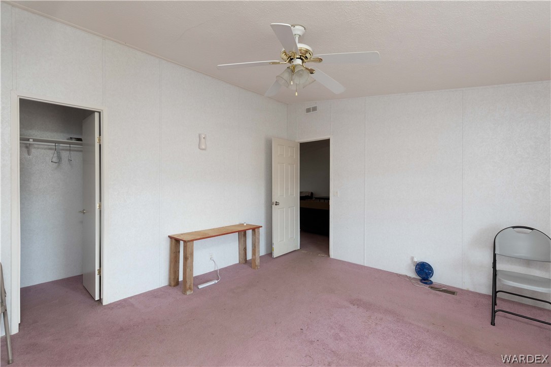 7374 Windmill Road Kingman, AZ 86401 - Photo 24 of 49 a view of an empty room with a chandelier fan
