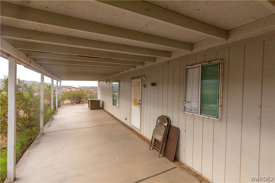 7374 Windmill Road Kingman, AZ 86401 - Photo 35 of 49 a view of a porch with a table and chairs