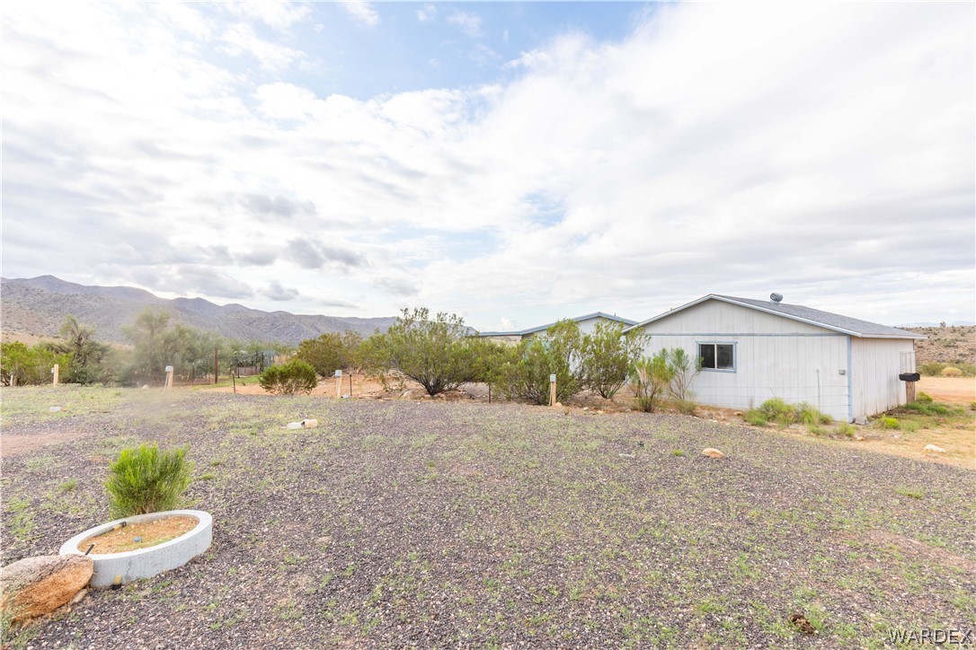 7374 Windmill Road Kingman, AZ 86401 - Photo 40 of 49 a view of a white house with a yard and plants