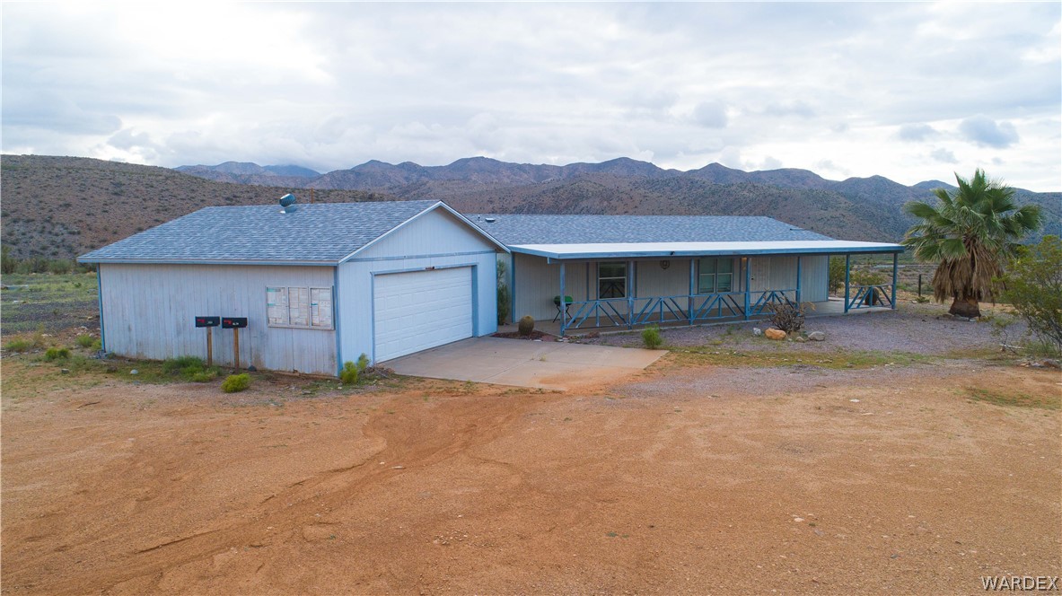 7374 Windmill Road Kingman, AZ 86401 - Photo 43 of 49 a front view of a house with a yard and garage