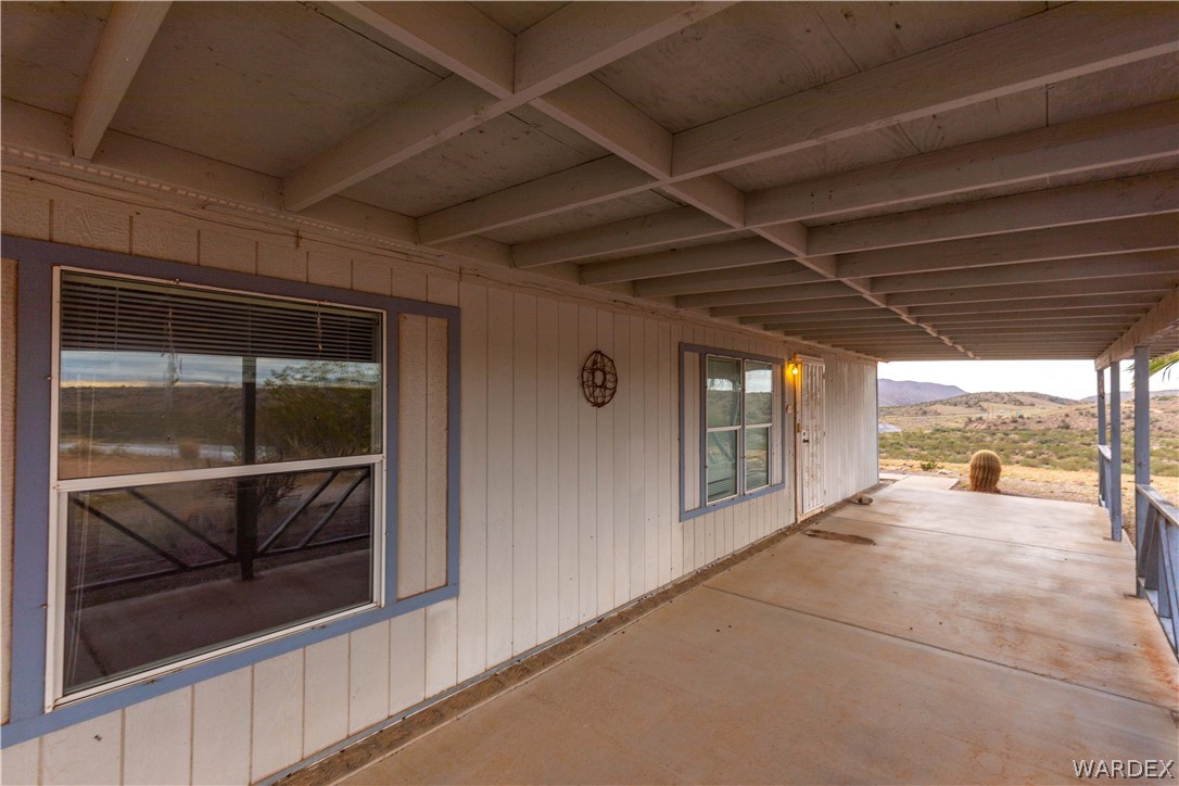 7374 Windmill Road Kingman, AZ 86401 - Photo 6 of 49 a view of a porch with a table and chairs
