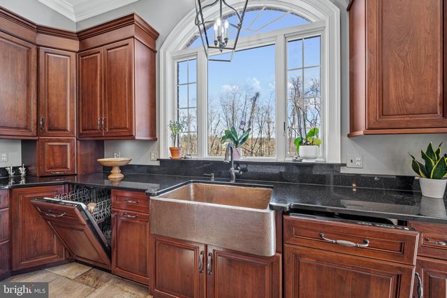 a kitchen with stainless steel appliances granite countertop a stove and a sink