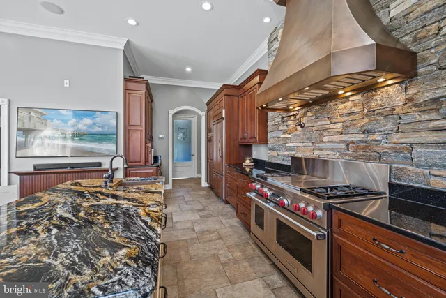 a large kitchen with kitchen island granite countertop a large counter top appliances and cabinets