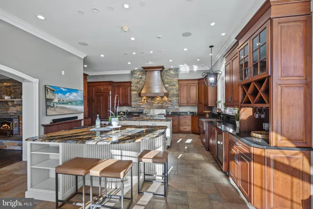 a kitchen with stainless steel appliances granite countertop a stove and cabinets