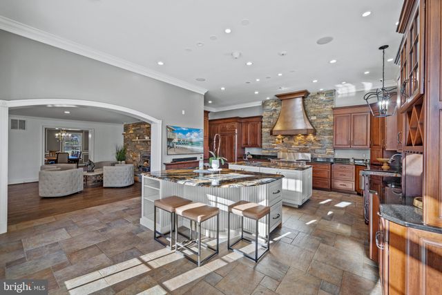 a view of kitchen with stainless steel appliances granite countertop a sink a stove and a dining table