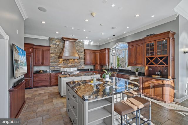 a bathroom with a granite countertop sink a toilet a mirror and shower
