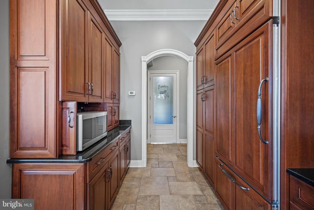 a bathroom with a granite countertop sink toilet mirror and shower