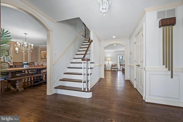 a view of a hallway with entryway wooden floor and front door