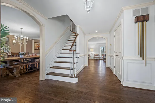 a view of a hallway with entryway wooden floor and front door