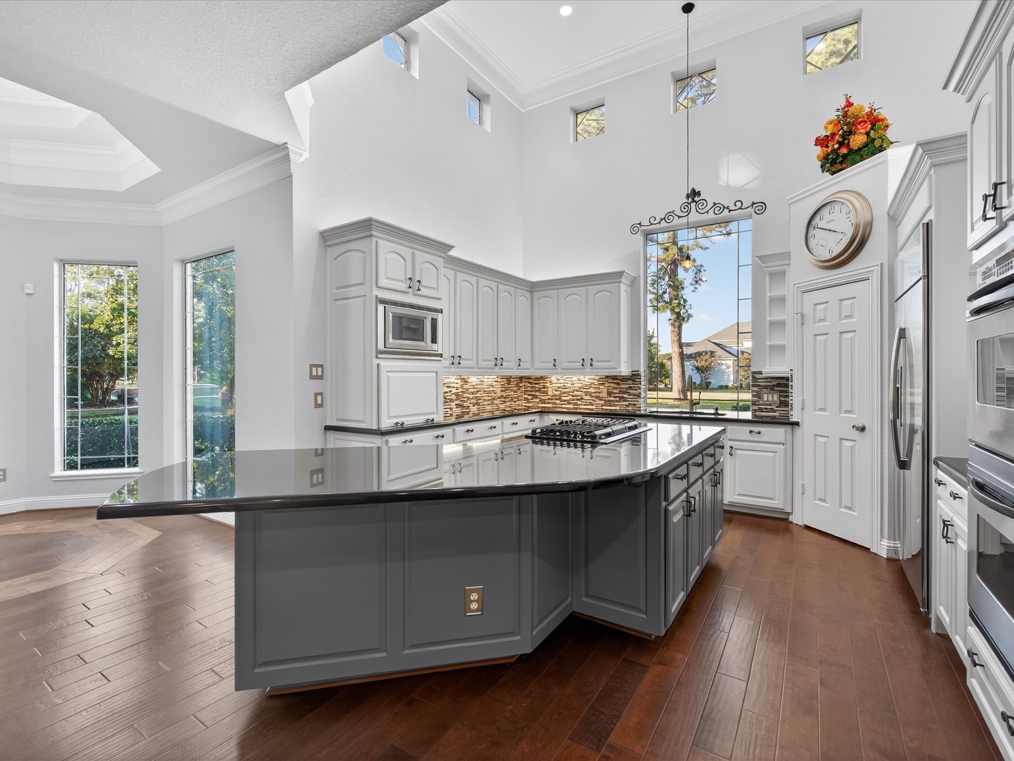 11 Gleannloch Estates Drive Spring, TX 77379 - Photo 16 of 50 The chef’s kitchen boasts a sprawling center island with a gas cooktop, perfect for culinary creations and entertaining guests.