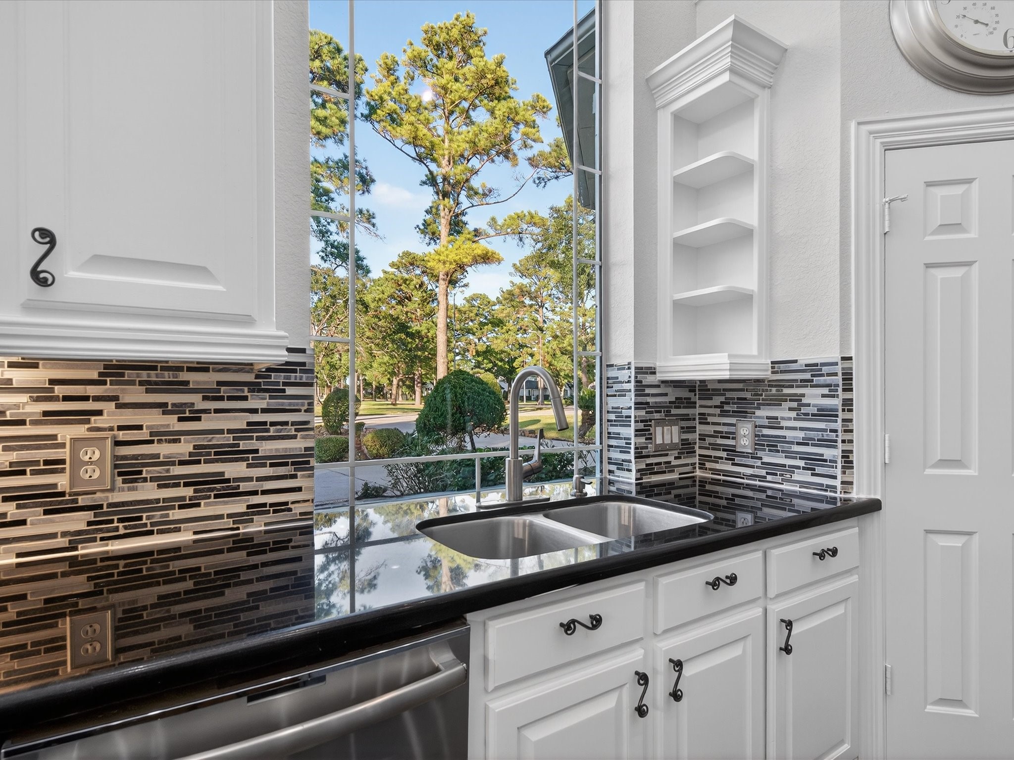 11 Gleannloch Estates Drive Spring, TX 77379 - Photo 18 of 50 Thoughtful features include pots-and-pans drawers, under-cabinet lighting, double ovens, and a walk-in pantry, combining style with functionality.