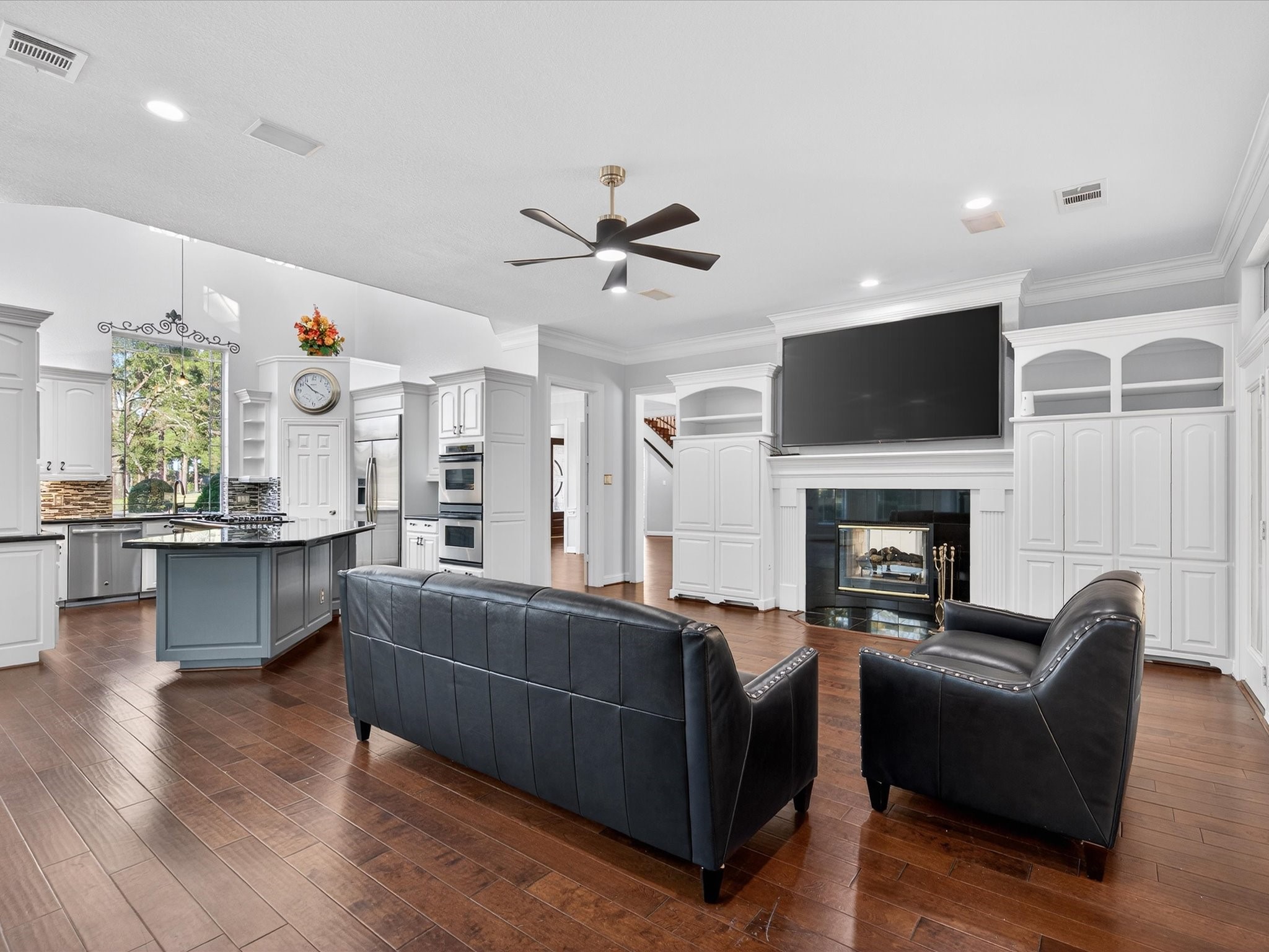 11 Gleannloch Estates Drive Spring, TX 77379 - Photo 19 of 50 The family room showcases custom built-ins and a Gaslog fireplace, offering a warm, inviting hub for everyday living.
