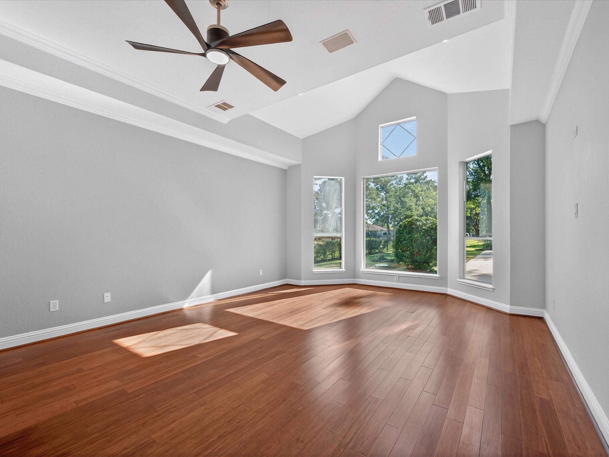11 Gleannloch Estates Drive Spring, TX 77379 - Photo 22 of 50 The expansive primary suite features crown molding, soaring ceilings, and a sitting area with panoramic views, creating a private retreat.