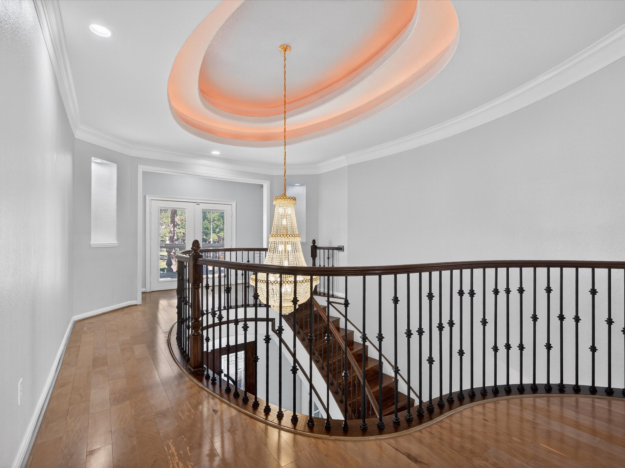 11 Gleannloch Estates Drive Spring, TX 77379 - Photo 25 of 50 Ascend the wrought-iron railing staircase to the second floor, where a tray ceiling is highlighted by a stunning chandelier.