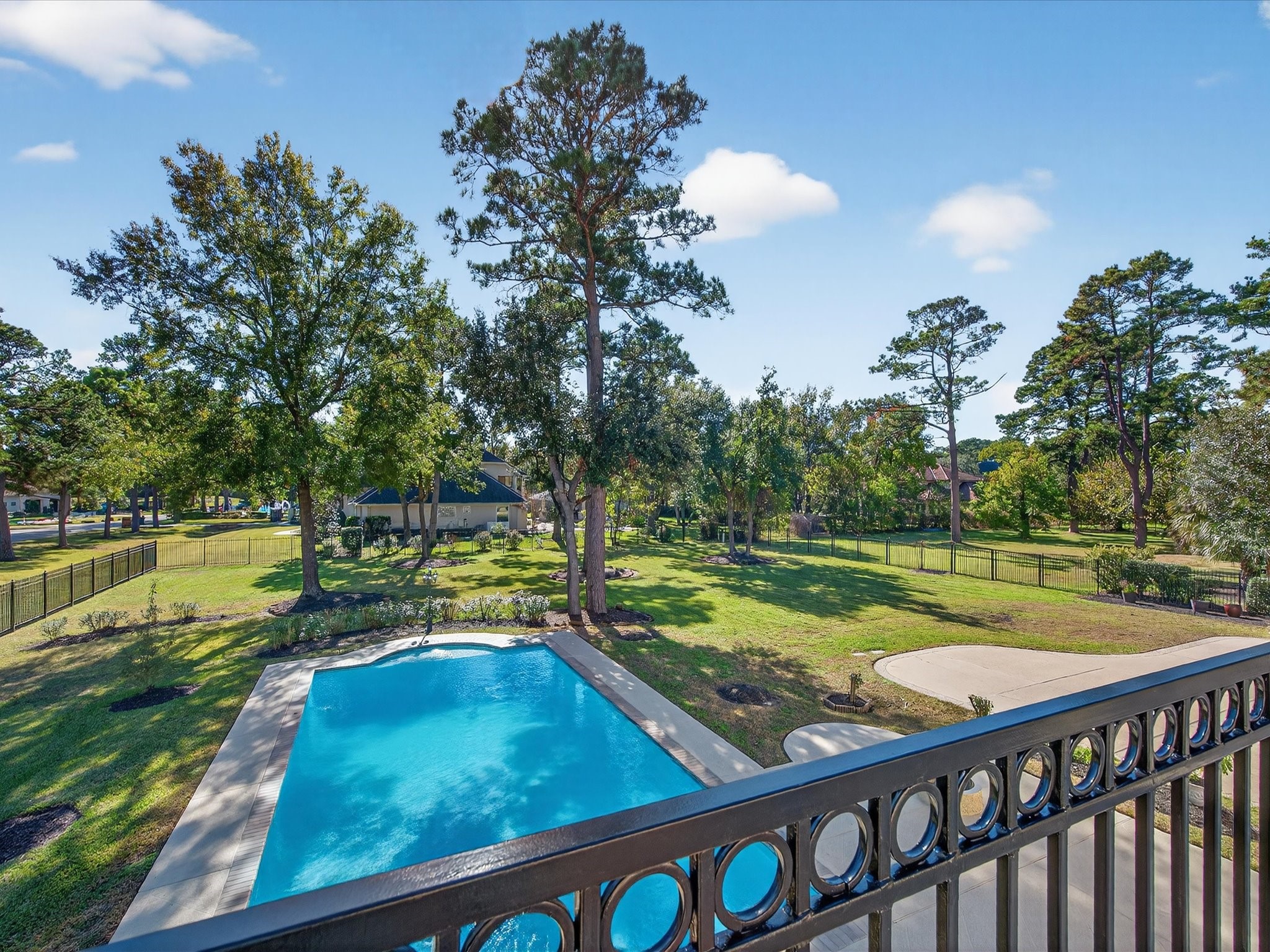 11 Gleannloch Estates Drive Spring, TX 77379 - Photo 30 of 50 From the balcony, enjoy sweeping views of the pool and expansive grounds, perfect for both relaxation and hosting.