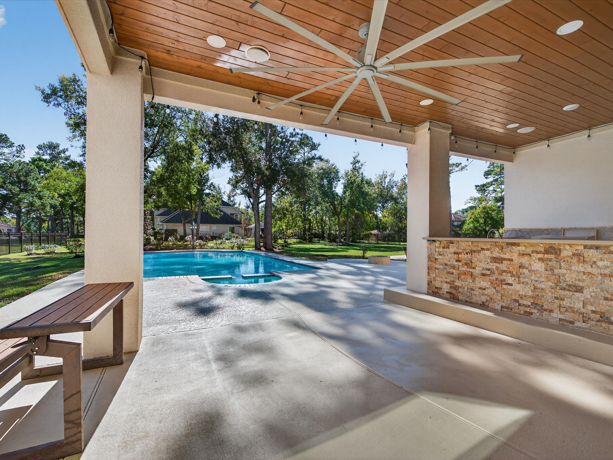11 Gleannloch Estates Drive Spring, TX 77379 - Photo 38 of 50 Another view of the covered patio showcases the pool and sprawling backyard, highlighting the home’s private oasis.