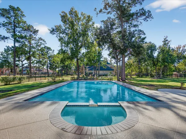 a view of a house with pool and chairs