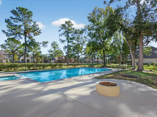 a view of a house with pool and chairs
