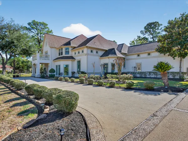 a front view of a house with a yard and outdoor seating