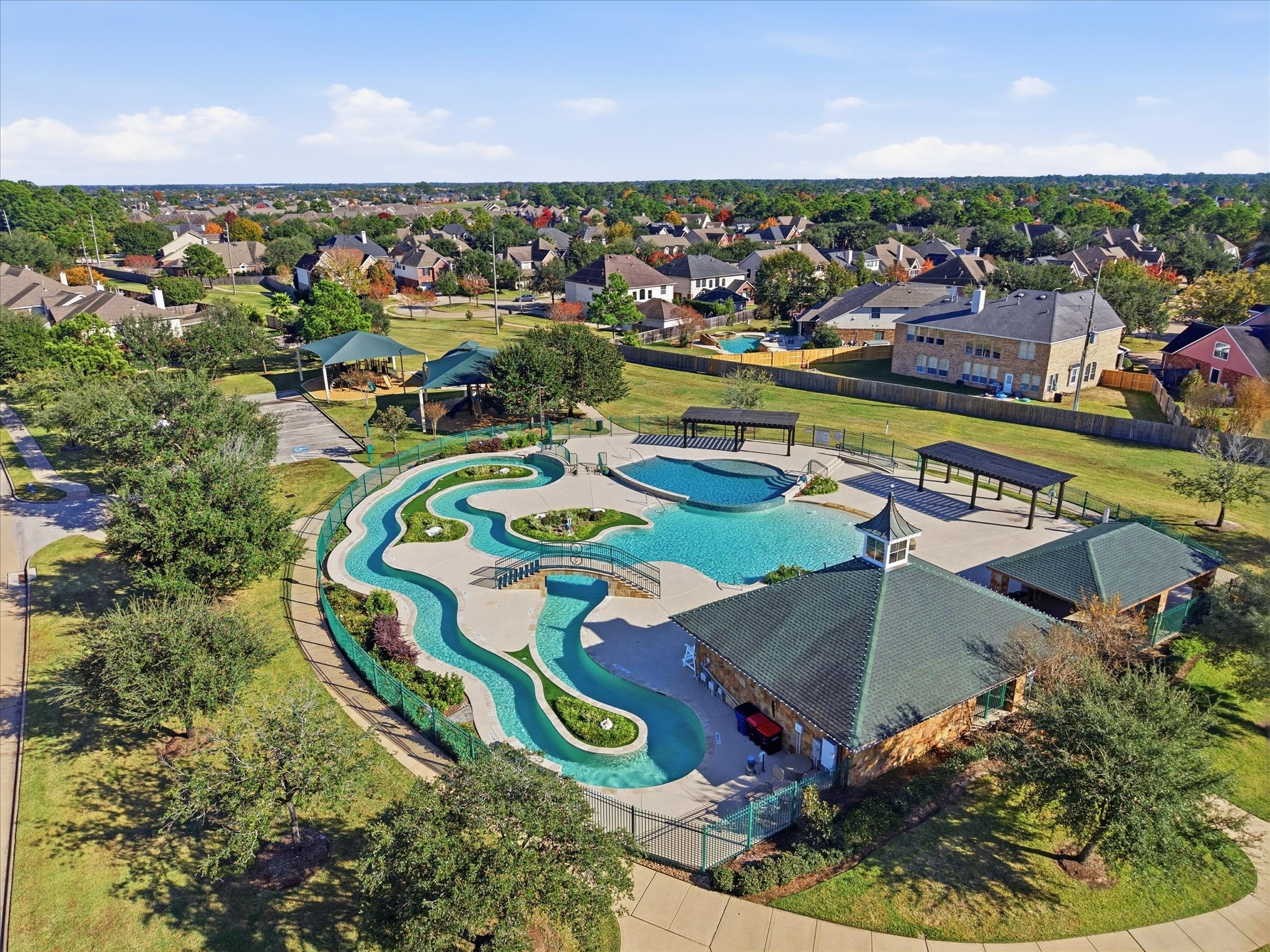 11 Gleannloch Estates Drive Spring, TX 77379 - Photo 47 of 50 The Gleannloch Farms clubhouse and community pool provide a central gathering place for residents to relax, connect, and enjoy organized events in a beautifully maintained setting.
