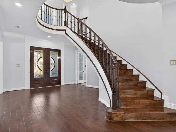 a view of entryway and hall with wooden floor