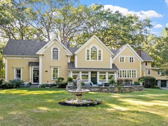 a front view of a house with swimming pool and porch