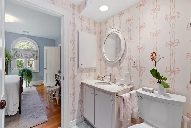 a bathroom with a granite countertop sink a large mirror and a window