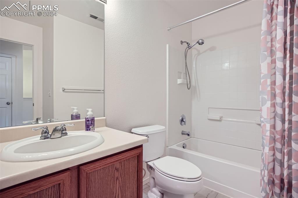 10581 Wells Point Fountain, CO 80817 - Photo 16 of 23 a bathroom with a sink toilet vanity and shower