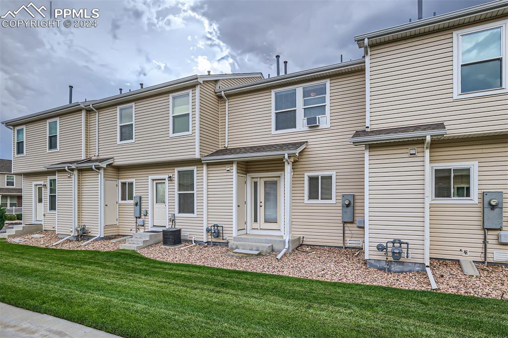 10581 Wells Point Fountain, CO 80817 - Photo 2 of 23 a front view of a house with a yard and outdoor seating