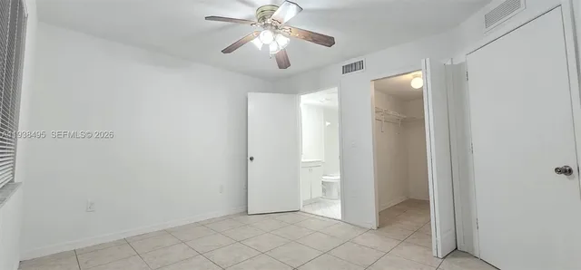 a view of a chandelier fan and entryway