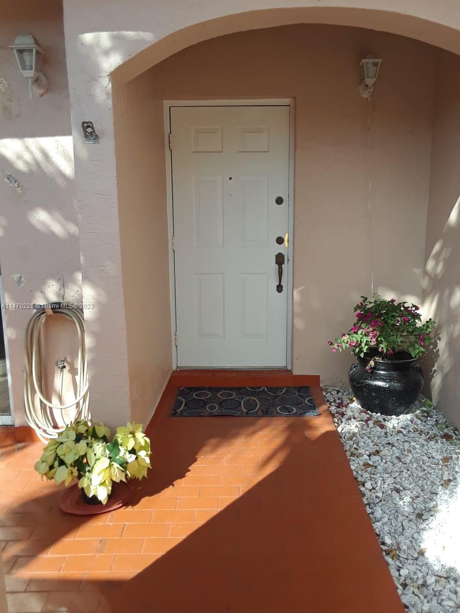 12853 Southwest 64th Lane, Unit 12853 Miami, FL 33183 - Photo 7 of 7 a front view of a house with a flower pot