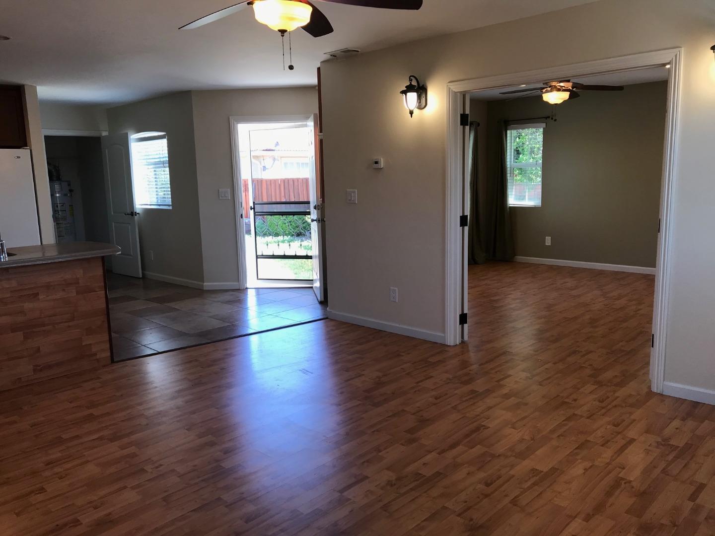 36733 Olive Street Newark, CA 94560 - Photo 12 of 16 an empty room with wooden floor and windows