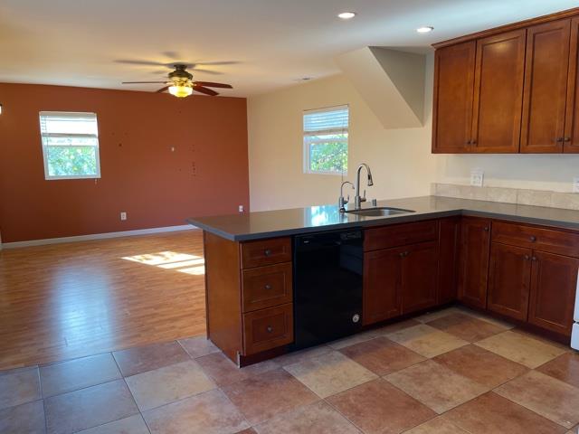 36733 Olive Street Newark, CA 94560 - Photo 3 of 16 a kitchen with a sink a stove cabinets and wooden floor