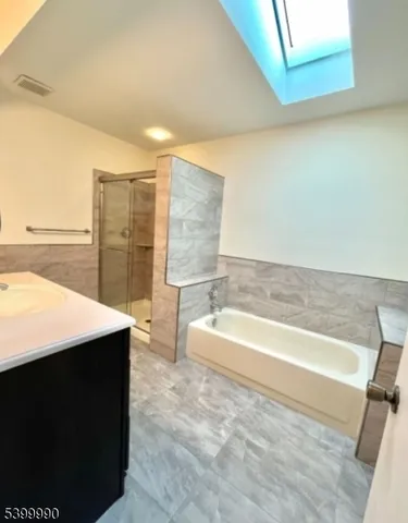 a bathroom with a bathtub and a sink