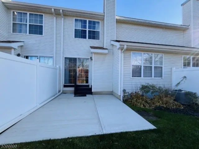 a view of backyard with plants and large window