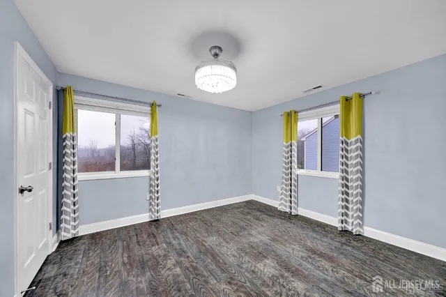 an empty room with windows and closet