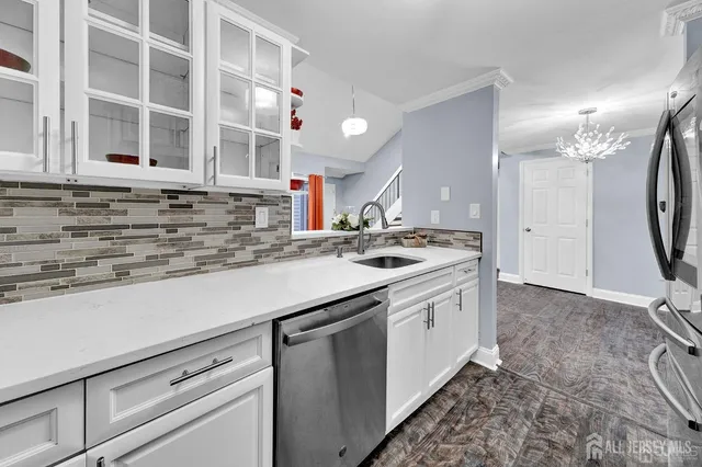 a kitchen with stainless steel appliances granite countertop a sink and a stove