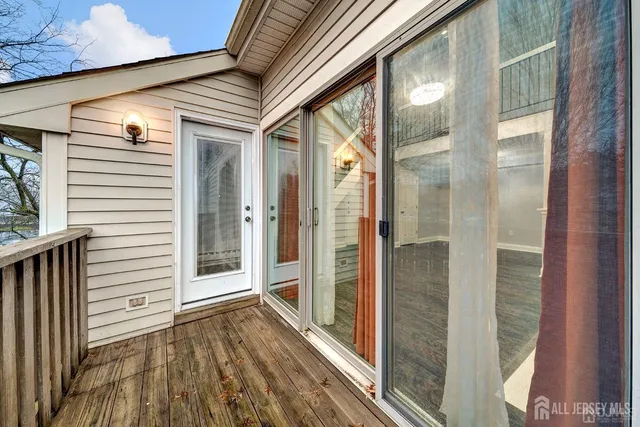 a view of a porch with wooden floor and door