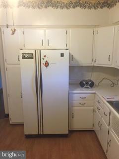 1829 Middleborough Road Baltimore, MD 21221 - Photo 12 of 20 a view of a kitchen with refrigerator and white cabinets