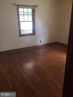 1829 Middleborough Road Baltimore, MD 21221 - Photo 10 of 20 an empty room with wooden floor and windows