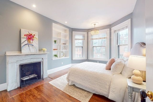 a bedroom with a bed and a fireplace