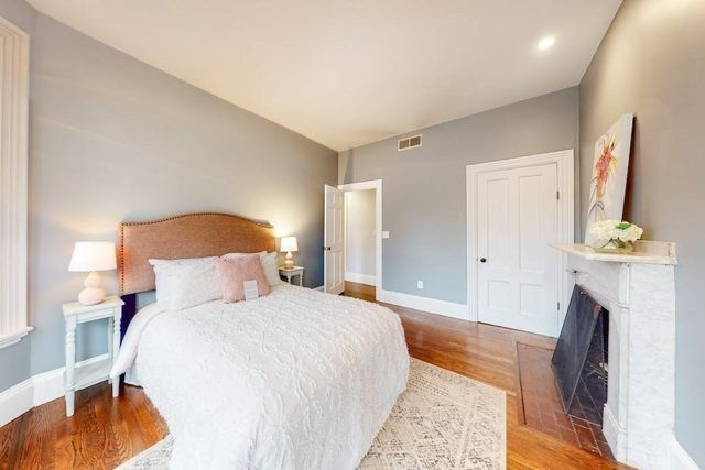 a bedroom with a bed and a fireplace