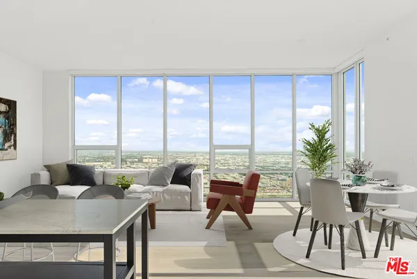 a living room with furniture and large windows