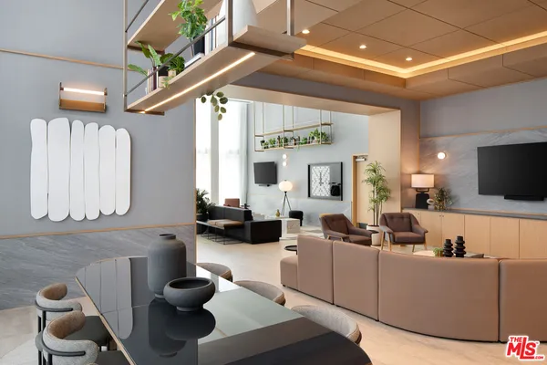 a living room with furniture and a potted plant