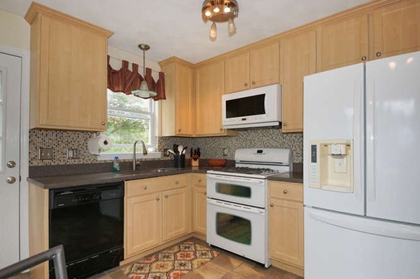 237 Acropolis Road Lowell, MA 01854 - Photo 7 of 22 a kitchen with a sink stove and microwave