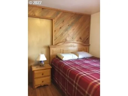 a bedroom with a bed and a lamp on table