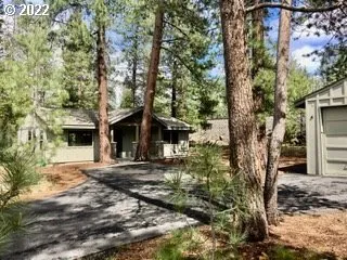 a view of a house with a tree in front of it