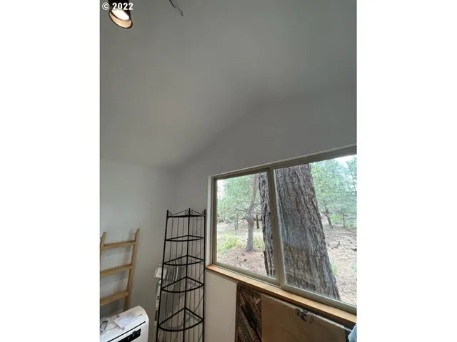 a view of a room that has a bed and a window