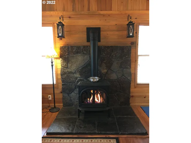 a kitchen with stainless steel appliances granite countertop a sink a stove and a wooden floors